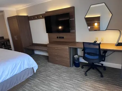 a hotel room with a desk and a computer at Holiday Inn Express & Suites Williamsport by IHG in Williamsport