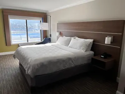 a hotel room with a large bed and a window at Holiday Inn Express & Suites Williamsport by IHG in Williamsport