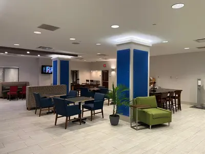 a dining room with tables and chairs at Holiday Inn Express & Suites Williamsport by IHG in Williamsport