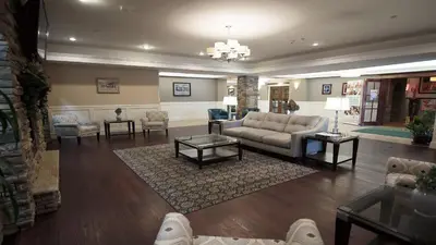 a living room with a couch and a table at Holiday Inn Williamsport by IHG in Williamsport