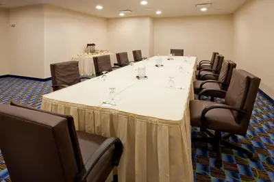 a conference room with a long table and chairs at Holiday Inn Williamsport by IHG in Williamsport