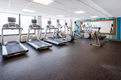 a gym with several treadmills and cardio machines at Holiday Inn Express & Suites Ft. Washington - Philadelphia by IHG in Fort Washington