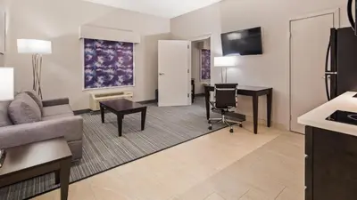 a living room with a couch and a desk at Best Western Plus Wilkes Barre-Scranton Airport Hotel in Pittston