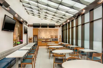 a dining room with tables and chairs at Fairfield By Marriott New York Manhattan Times Square in New York