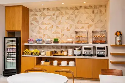 a restaurant with a counter with aasteryasteryasteryasteryasteryasteryasteryasteryastery at Fairfield By Marriott New York Manhattan Times Square in New York