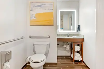 a bathroom with a toilet and a sink at Comfort Suites East Brunswick - South River in East Brunswick