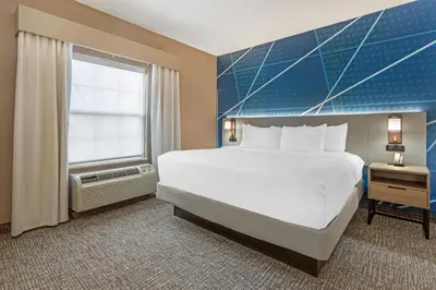 a bedroom with a large bed and a window at Comfort Suites East Brunswick - South River in East Brunswick