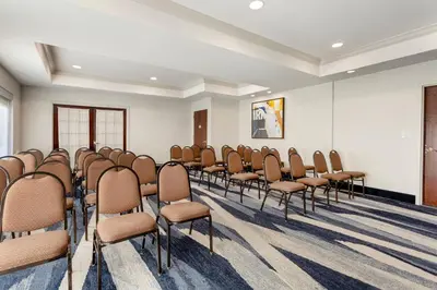 a room with rows of chairs in a room at Comfort Suites East Brunswick - South River in East Brunswick