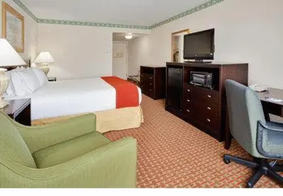 a hotel room with a bed and a desk and a television at Holiday Inn Express Hotel & Suites Easton by IHG in Easton