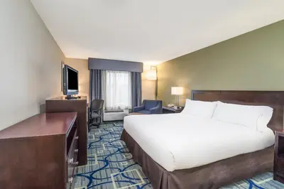 a hotel room with a large bed and a desk at Holiday Inn Express Hotel & Suites Easton by IHG in Easton
