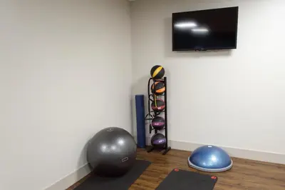 a room with a tv and some balls and a yoga mat at Holiday Inn Express Hershey-Harrisburg Area by IHG in Hershey