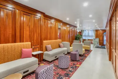 a waiting room with a bunch of chairs and tables at The Mayfair Hotel Times Square, an Ascend Collection in New York