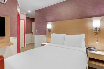 a hotel room with a bed and a tv at The Mayfair Hotel Times Square, an Ascend Collection in New York