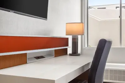 a desk with a lamp and a chair at Delta Hotels by Marriott Allentown Lehigh Valley in Fogelsville