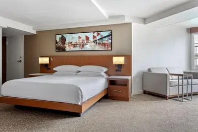 a bedroom with a large bed and a desk at Delta Hotels by Marriott Allentown Lehigh Valley in Fogelsville