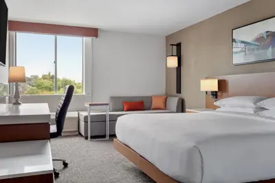 a hotel room with a large bed and a desk at Delta Hotels by Marriott Allentown Lehigh Valley in Fogelsville