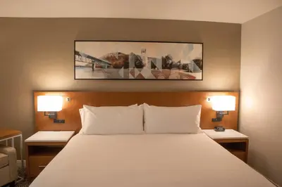 a bed in a hotel room with two lamps at Delta Hotels by Marriott Allentown Lehigh Valley in Fogelsville