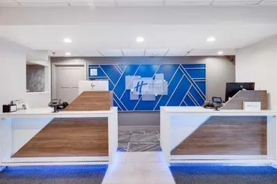 an office with two reception desks with a blue wall at Holiday Inn Express Wilkes Barre East by IHG in Wilkes-Barre