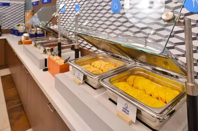 a buffet line with trays of food on display at Holiday Inn Express & Suites White Haven - Poconos by IHG in White Haven
