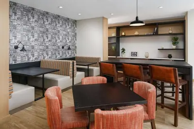 a restaurant with tables and chairs and a bar at Hampton Inn Manhattan-35th St Empire State Bldg in New York