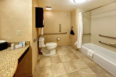 a bathroom with a toilet and a bath tub at Hampton Inn & Suites Chadds Ford in Glen Mills
