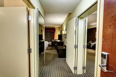 a hallway of a hotel room with a door open at Hampton Inn & Suites Chadds Ford in Glen Mills