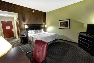 a hotel room with a bed and a television at Hampton Inn & Suites Chadds Ford in Glen Mills