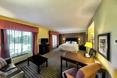a hotel room with a bed and a desk at Hampton Inn & Suites Chadds Ford in Glen Mills