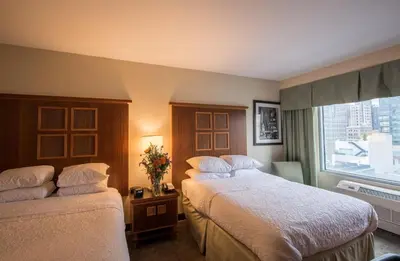 a hotel room with two beds and a window at SoHo 54 in New York