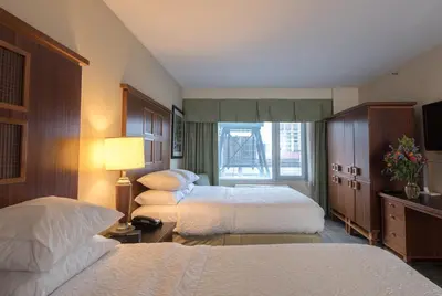 a hotel room with two beds and a window at SoHo 54 in New York