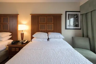 a hotel room with a bed and a desk with a lamp at SoHo 54 in New York