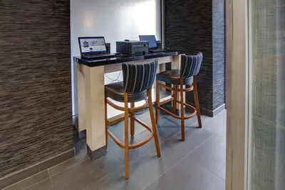 a bar with two chairs and a desk with a computer at SoHo 54 in New York