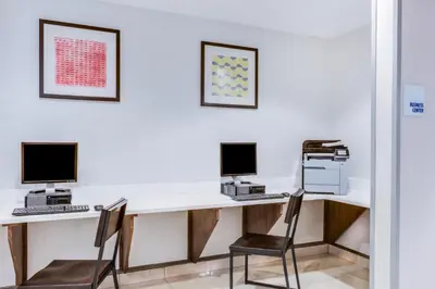 an office with two computers on a desk with two chairs at Holiday Inn Express Hotel & Suites Bethlehem by IHG in Bethlehem