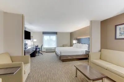 a large hotel room with a bed and a couch at Holiday Inn Express Hotel & Suites Bethlehem by IHG in Bethlehem