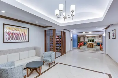 a living room with a couch and chairs at Holiday Inn Express Hotel & Suites Bethlehem by IHG in Bethlehem