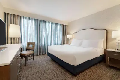 a hotel room with a bed and a desk at Embassy Suites by Hilton Philadelphia Valley Forge in Wayne