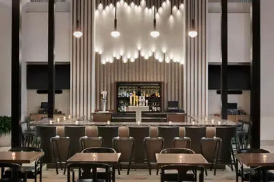 a bar in a restaurant with chairs and tables at Embassy Suites by Hilton Philadelphia Valley Forge in Wayne