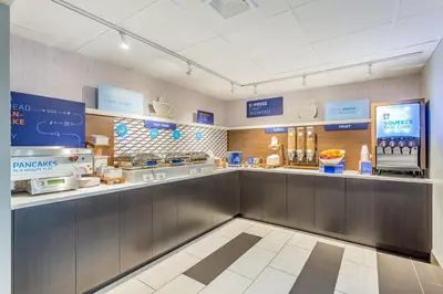a fast food restaurant with a counter with food at Holiday Inn Express Ramsey Mahwah by IHG in Ramsey
