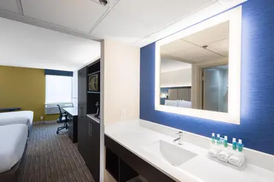 a bathroom with a sink and a large mirror at Holiday Inn Express Ramsey Mahwah by IHG in Ramsey