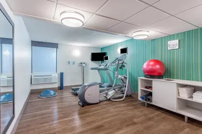 a room with a hair salon with a red helmet at Holiday Inn Express Ramsey Mahwah by IHG in Ramsey