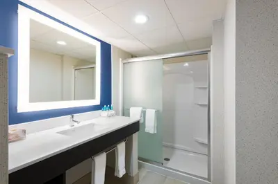 a bathroom with a sink and a shower at Holiday Inn Express Ramsey Mahwah by IHG in Ramsey