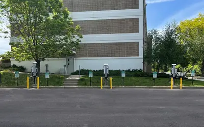 a parking lot with parking meters in front of a building at Holiday Inn Express Ramsey Mahwah by IHG in Ramsey