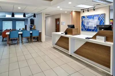 an office lobby with a reception desk and chairs at Holiday Inn Express Lewisburg - New Columbia by IHG in New Columbia