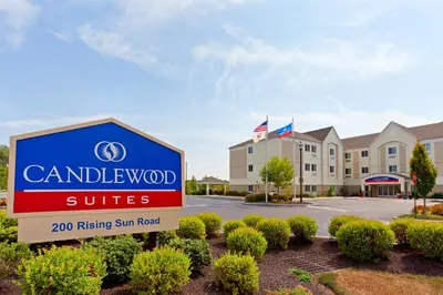 a sign in front of a building with a hotel at Candlewood Suites Bordentown-Trenton by IHG in Bordentown