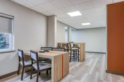 an office with chairs and a table in a room at Candlewood Suites Bordentown-Trenton by IHG in Bordentown