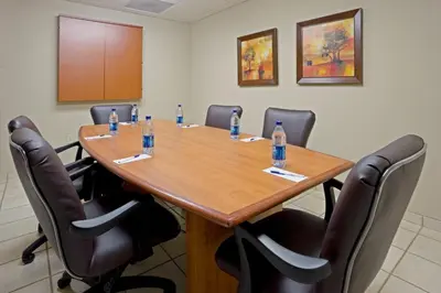 a conference room with a table with bottles of water on it at Candlewood Suites Bordentown-Trenton by IHG in Bordentown