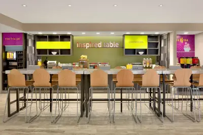 a conference room with a table and chairs at Home2 Suites By Hilton Hasbrouck Heights in Hasbrouck Heights