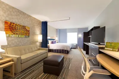 a hotel room with a couch and a bed at Home2 Suites By Hilton Hasbrouck Heights in Hasbrouck Heights