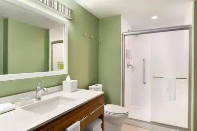 a bathroom with a white sink and a shower at Home2 Suites By Hilton Hasbrouck Heights in Hasbrouck Heights