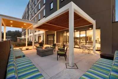 a patio with lounge chairs and a fire pit at Home2 Suites By Hilton Hasbrouck Heights in Hasbrouck Heights